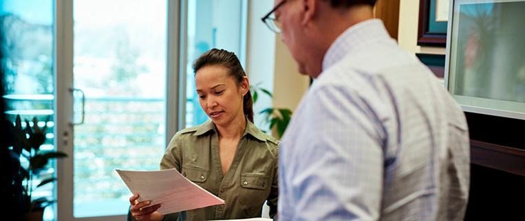 woman reading report in office